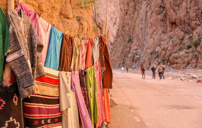 assorted clothes beside rock cliff