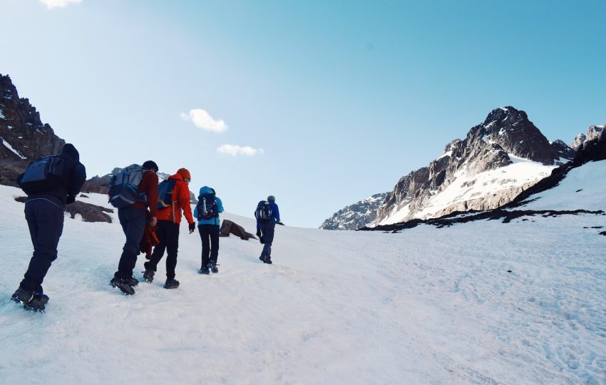 a group of people standing on a snowy mountain